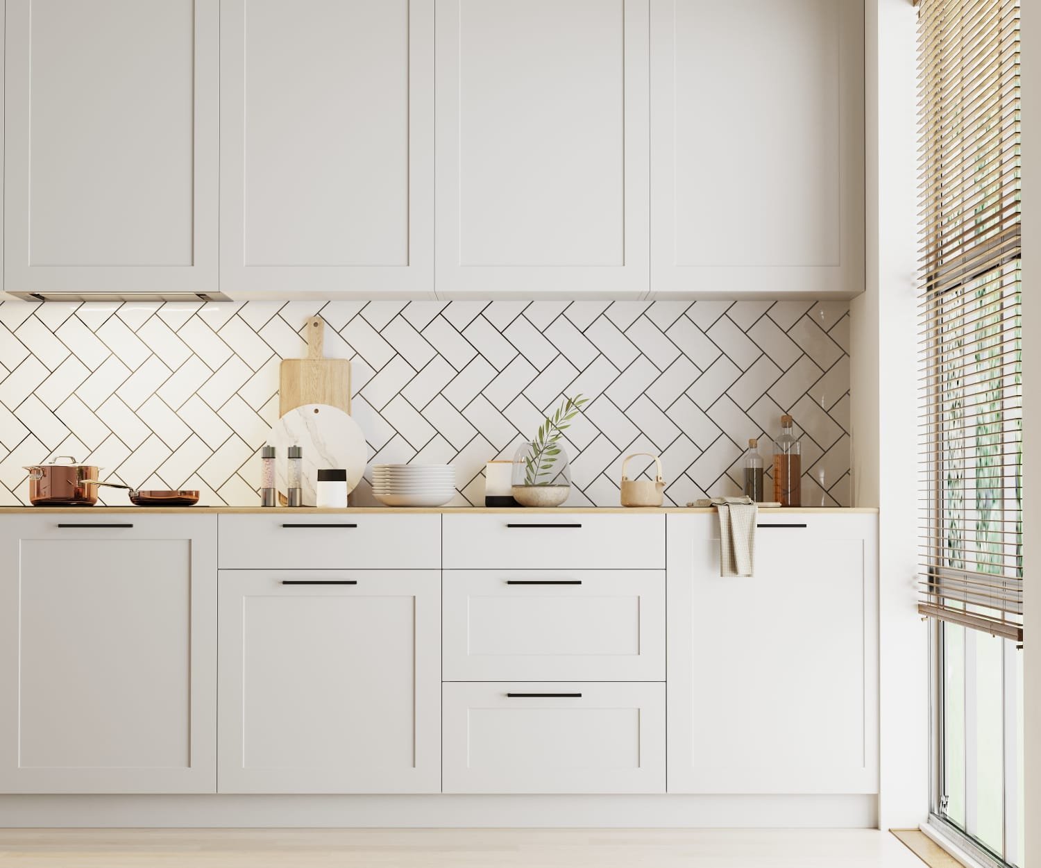 A resurfaced kitchen with light grey shaker-style cabinet doors and a herringbone tile splashback
