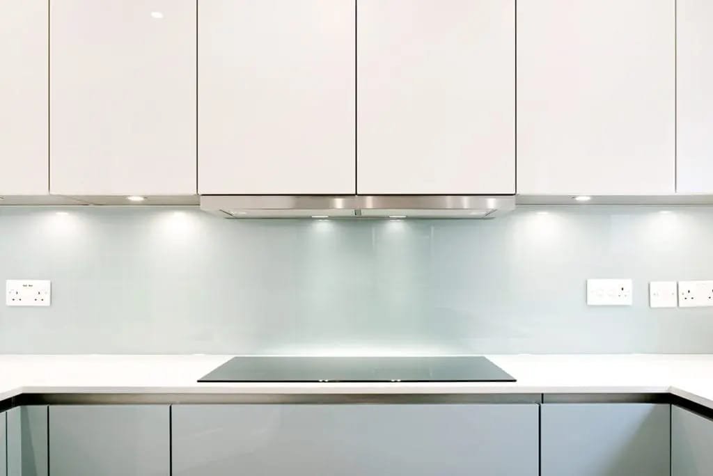 A close-up of a new glass kitchen splashback